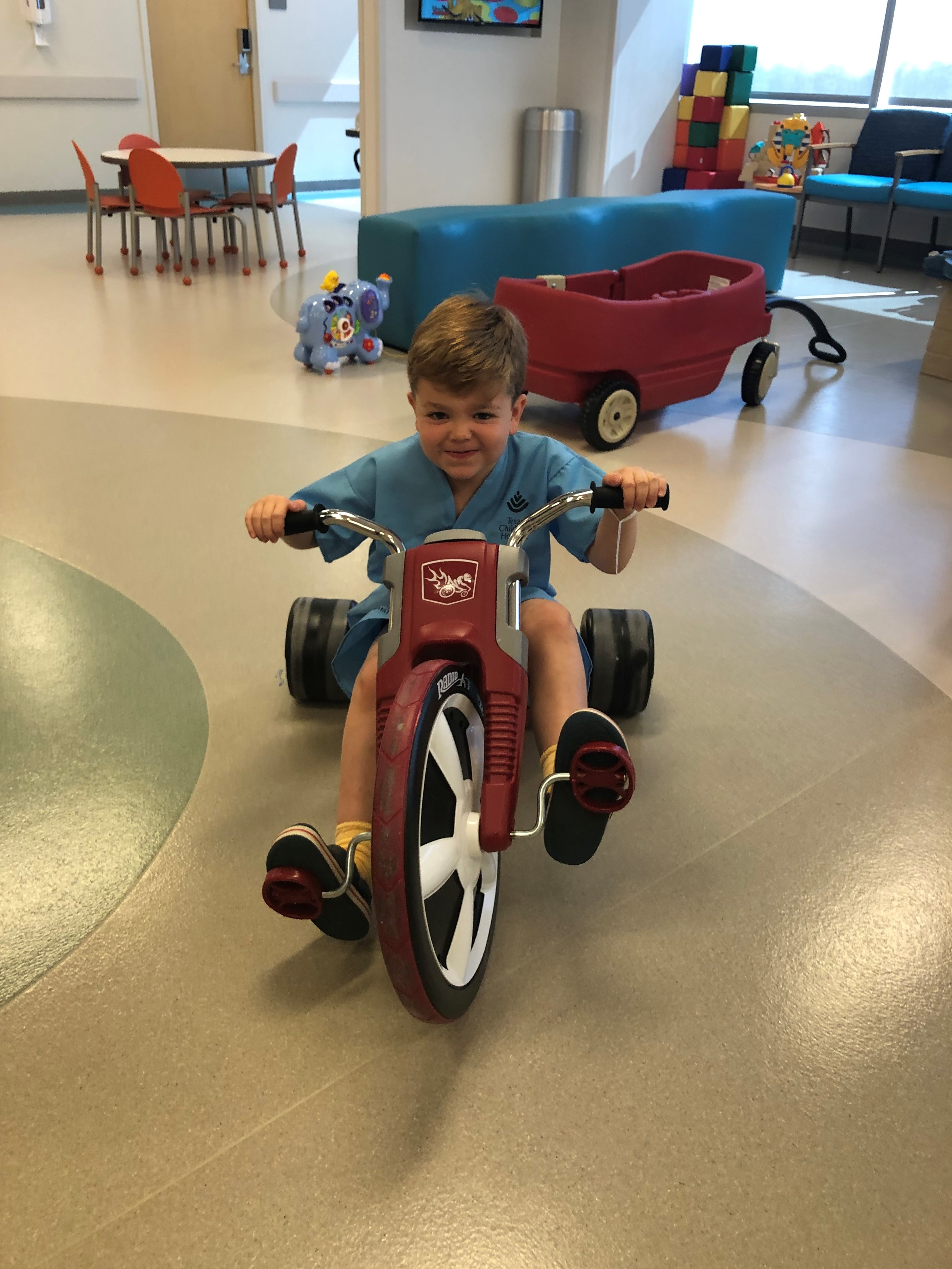 child riding motocycle in hospital