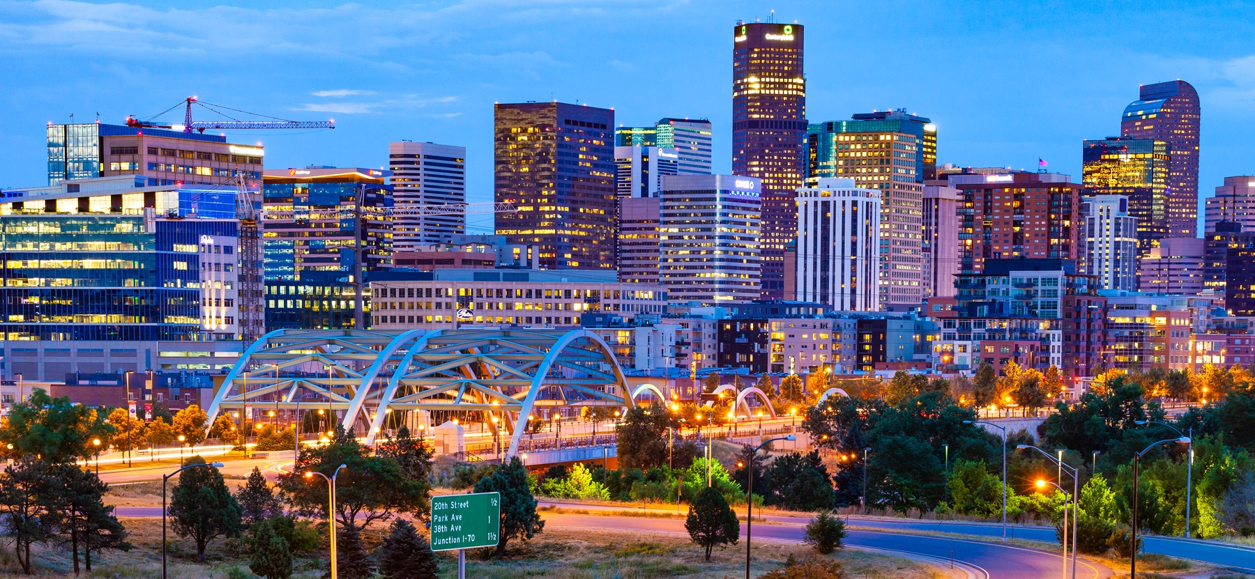 Denver skyline lit up at dusk.