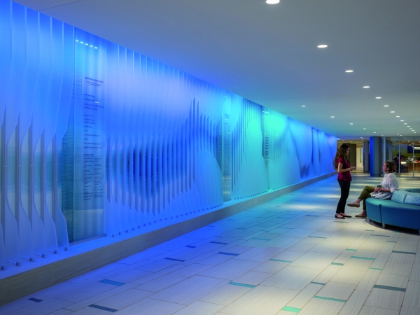 The illuminated wall represents the San Antonio River, as well as the calming therapeutic aspects of water at The Children's Hospital of San Antonio.