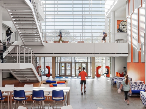 University student center with bright light shining into the room through expansive windows. 