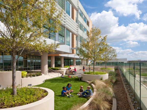 Children sitting on grass at Nemours Hospital.