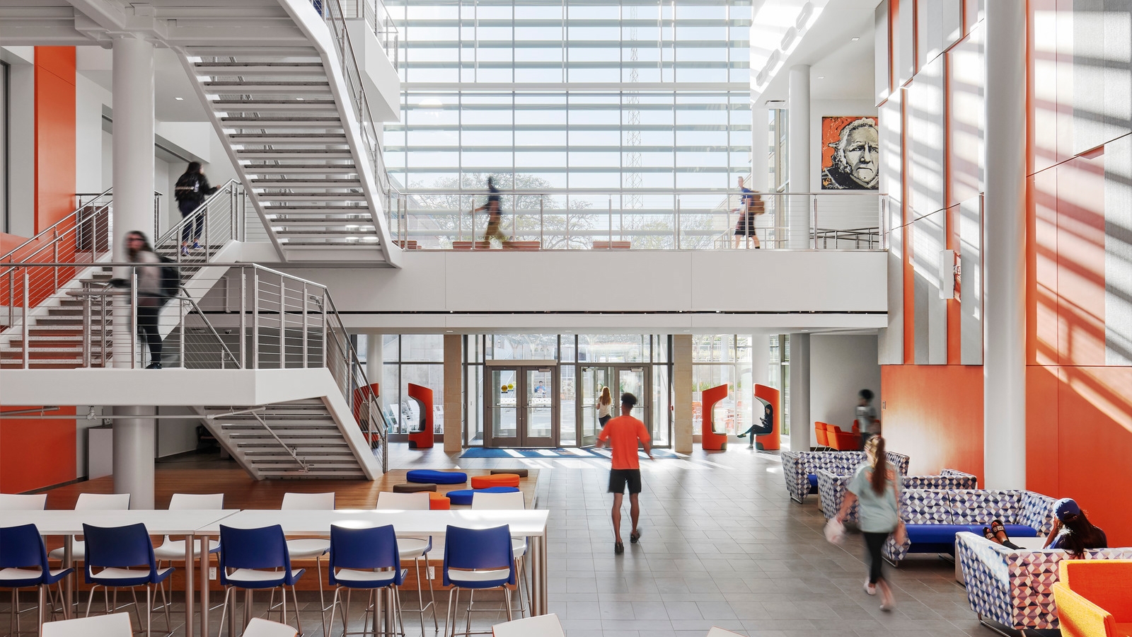 University student center with bright light shining into the room through expansive windows. 