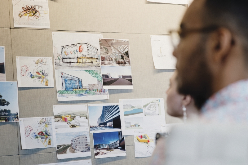 people looking at architectural drawings